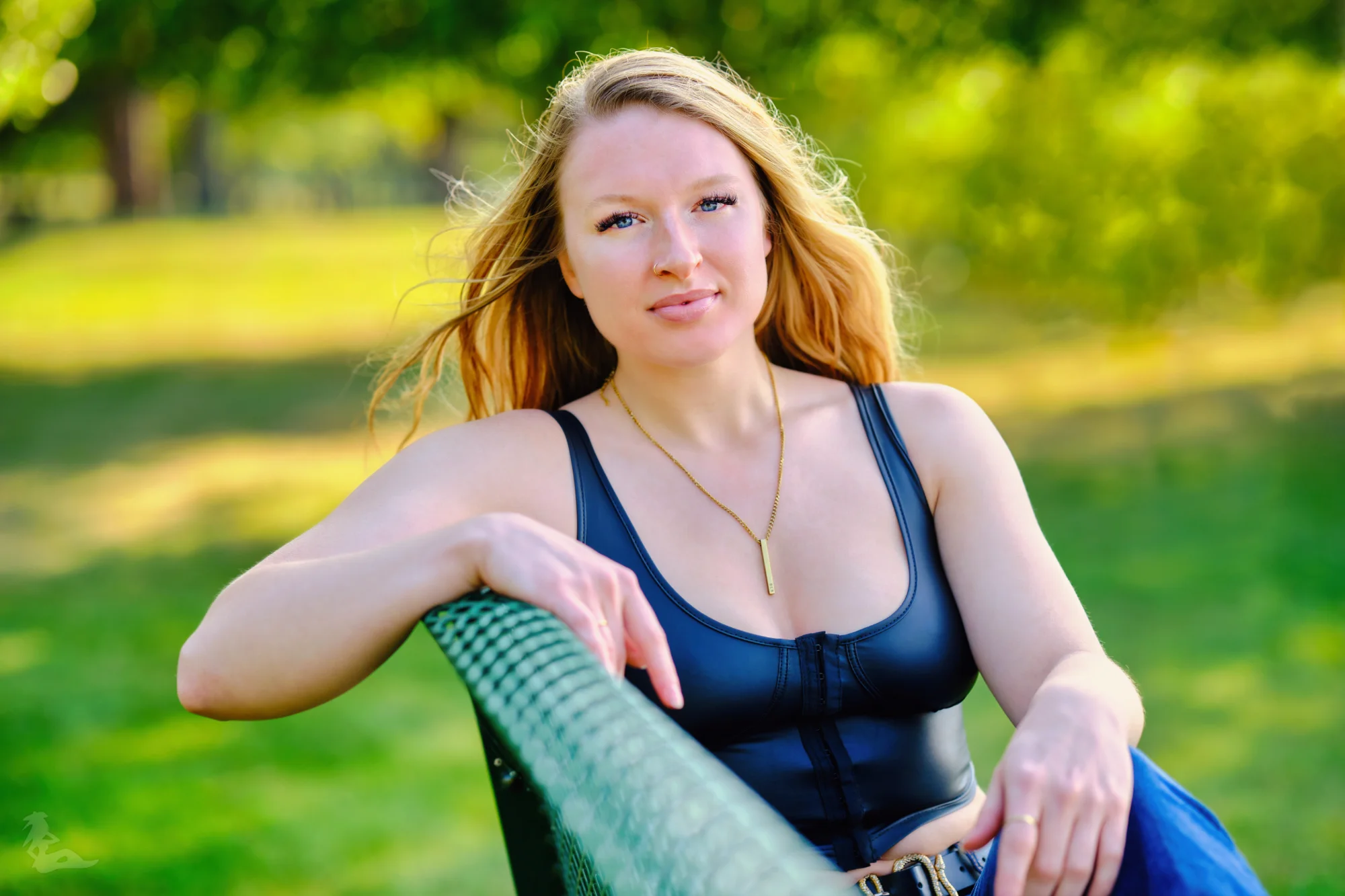Katelyn sitting on bench in black top